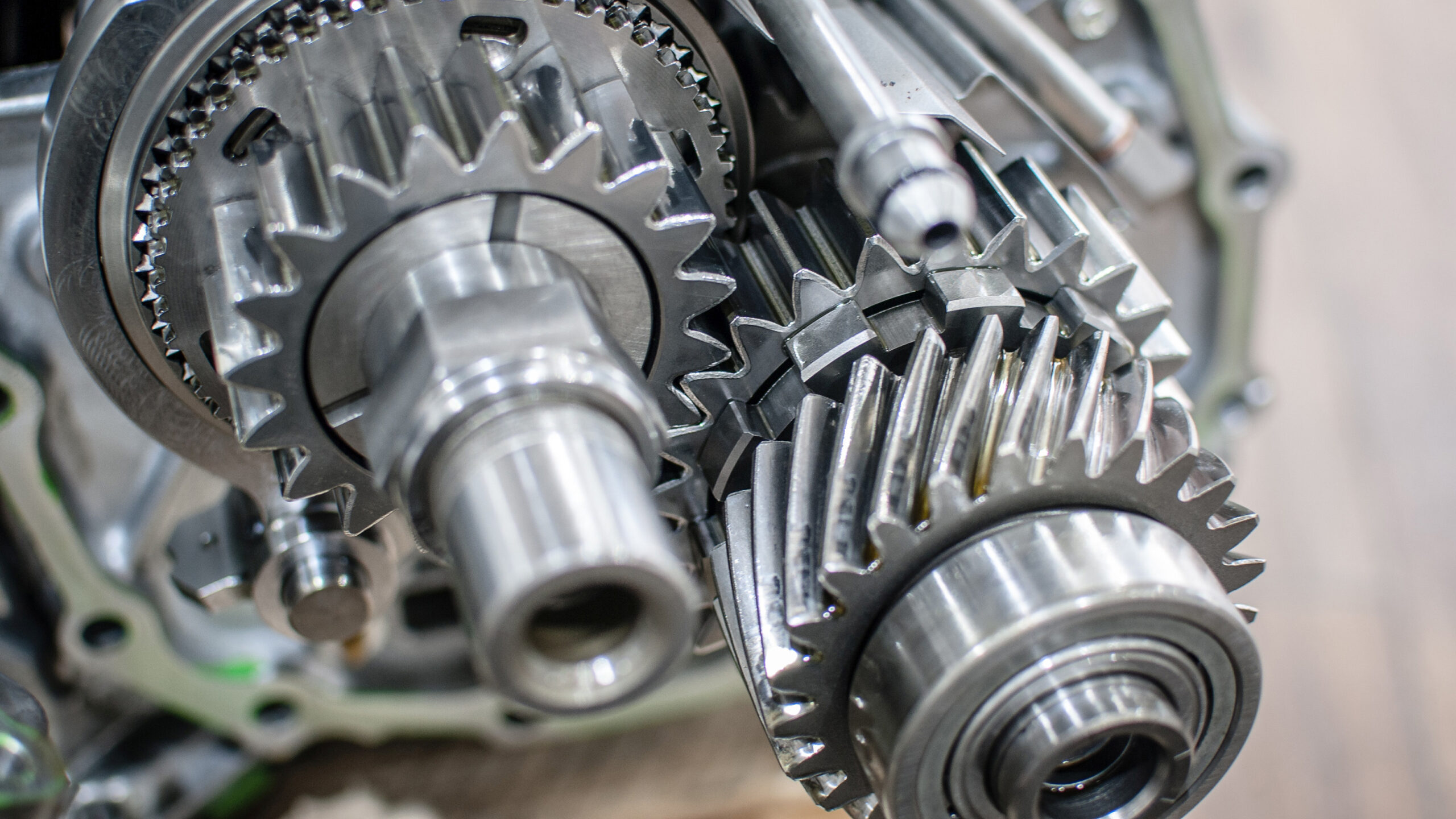 Close-up view of metal gears and shafts from a car transmission, showing intricate details of the machinery.