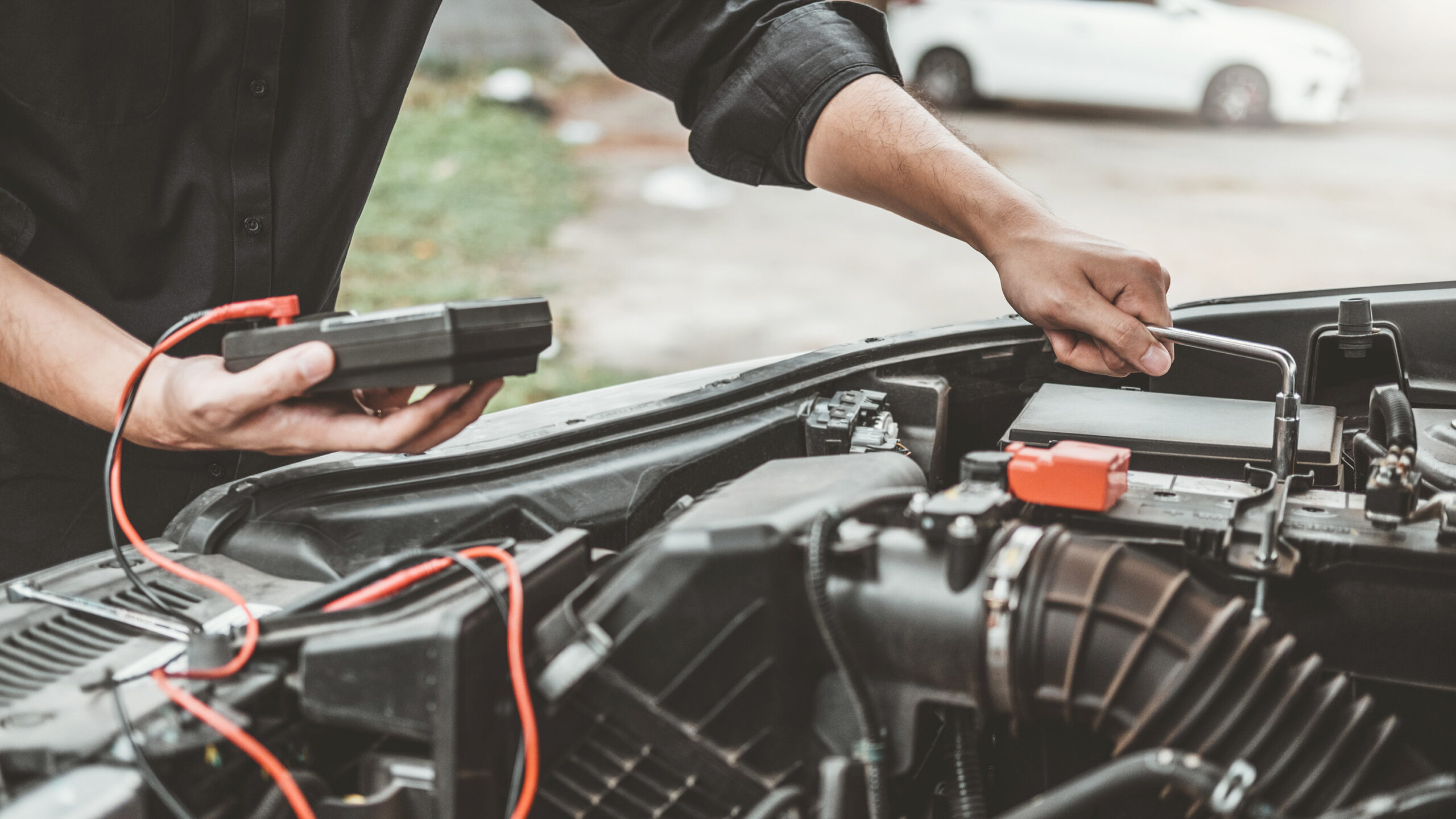 Auto mechanic working in garage Technician Hands of car mechanic working in auto repair Service and Maintenance car battery check.